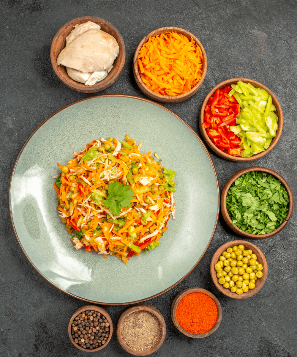 Fresh salad ingredients arranged around a plated dish